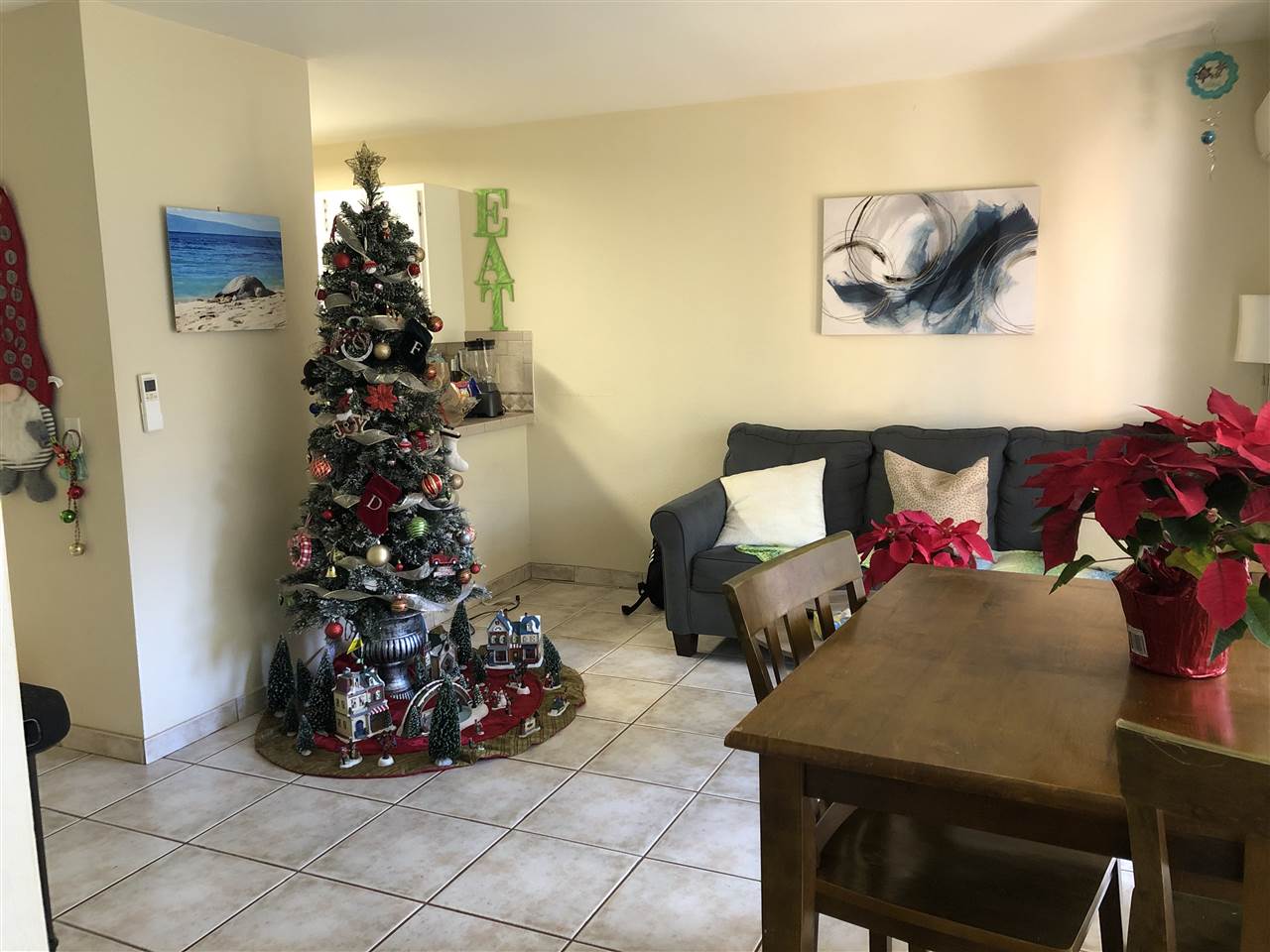 3740 Lower Honoapiilani Road, Unit B103 Lahaina, HI 96761 - Photo 3 of 16 a living room with furniture and flower vase