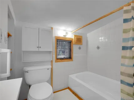 a bathroom with a bathtub and shower