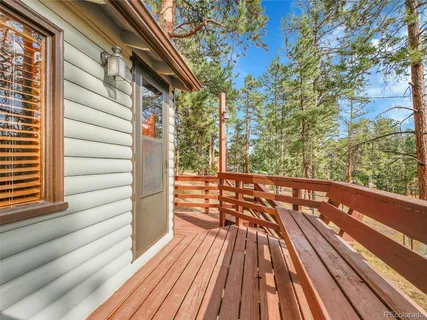 a view of balcony with wooden floor and fence