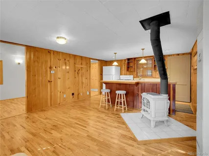 a dining room with furniture and wooden floor