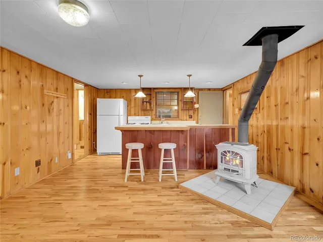 a kitchen with a refrigerator a sink dishwasher and a stove with wooden floor