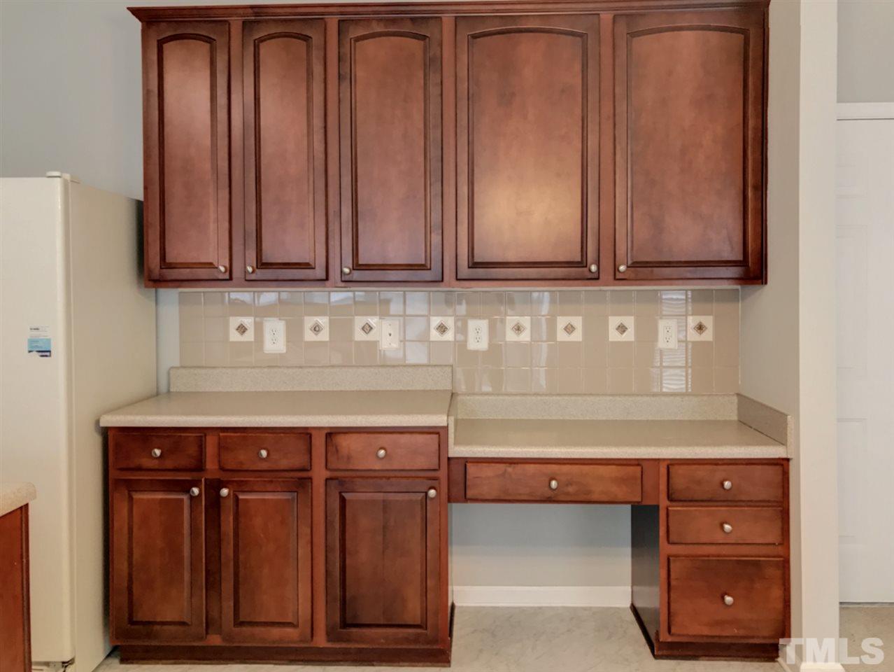 208 Rapp Lane Apex, NC 27502 - Photo 11 of 16 a view of cabinets and wooden cabinets