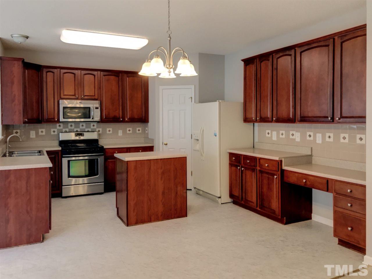 208 Rapp Lane Apex, NC 27502 - Photo 10 of 16 a kitchen with stainless steel appliances granite countertop a stove a sink dishwasher a refrigerator and a oven