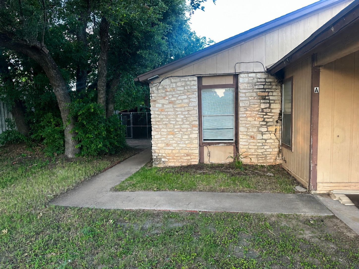 2602 South Bagdad Road, Unit A Leander, TX 78641 - Photo 1 of 26 A stone-fronted dwelling with mature trees and a private walkway.