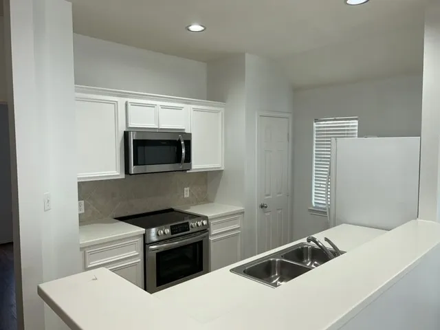 a kitchen with a stove and a microwave