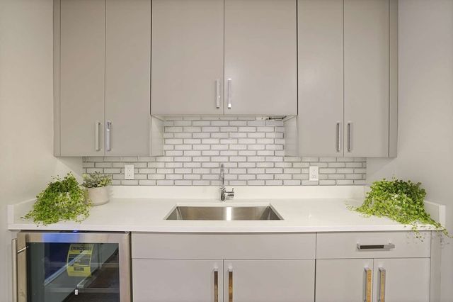 a kitchen with a sink and cabinets