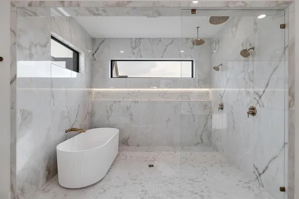 a bathroom with a double vanity sink a mirror and shower
