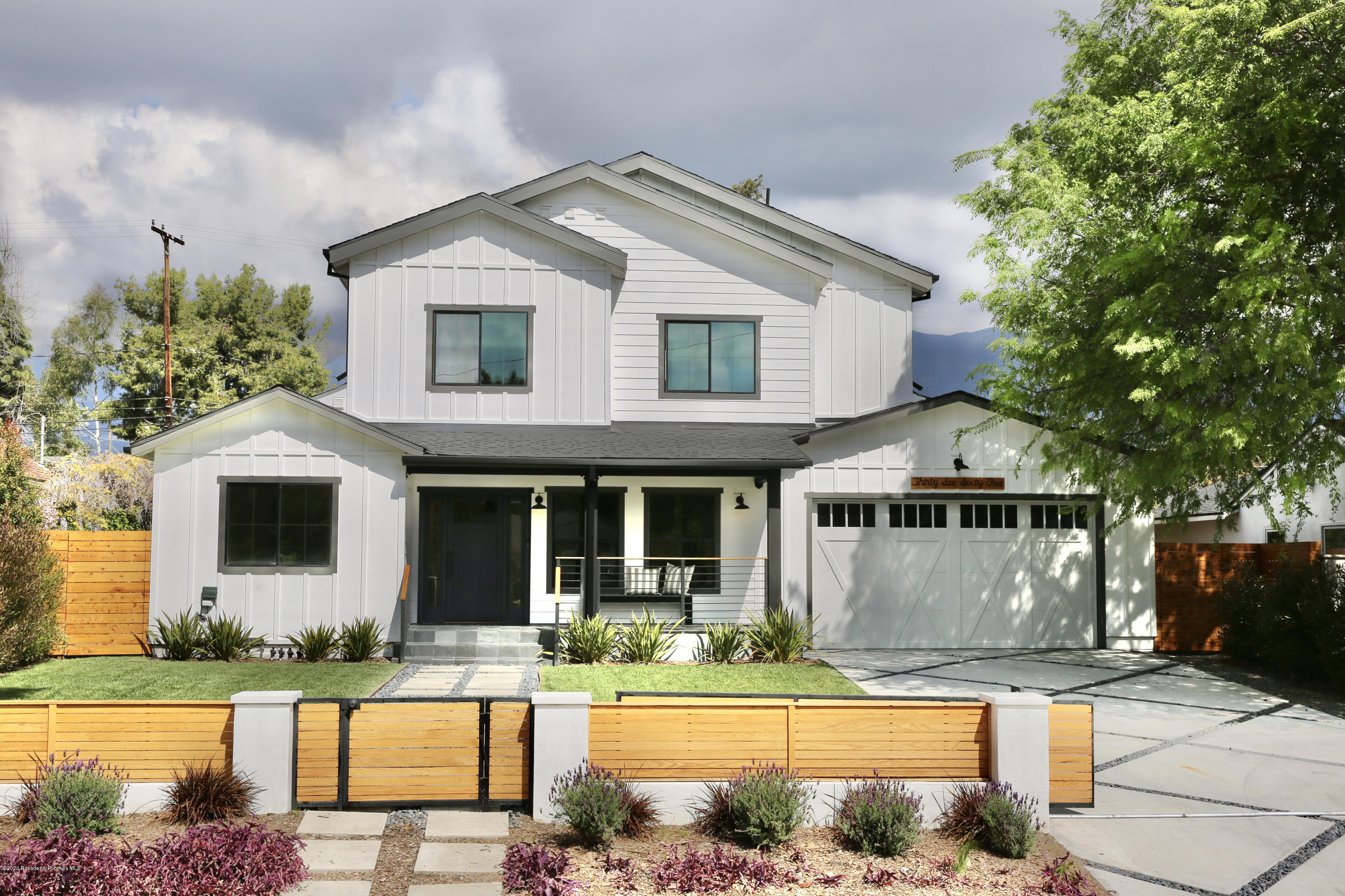 a front view of a house with swimming pool and glass windows