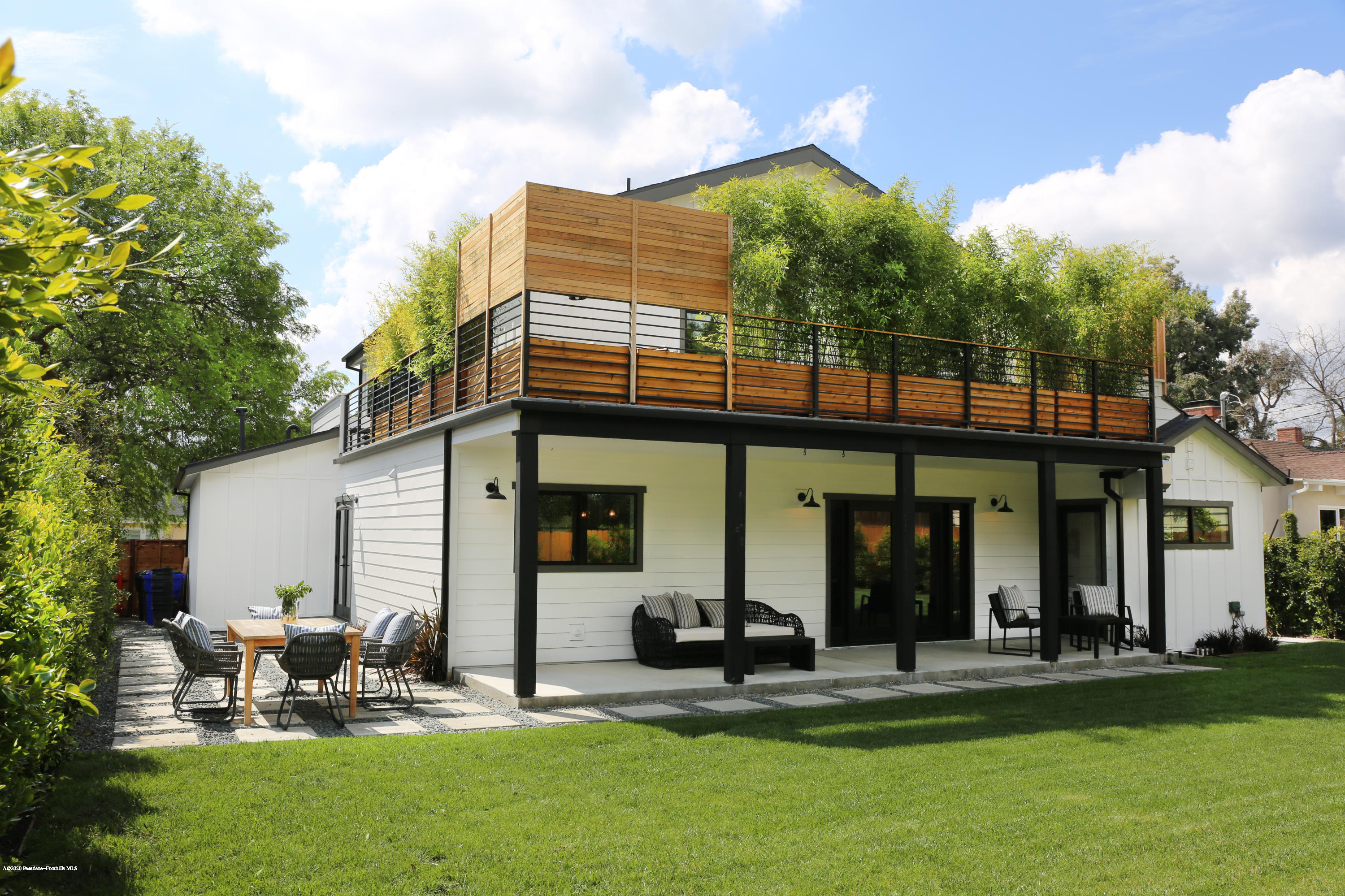 3665 Thorndale Road Pasadena, CA 91107 - Photo 13 of 45 a view of a patio with table and chairs under an umbrella