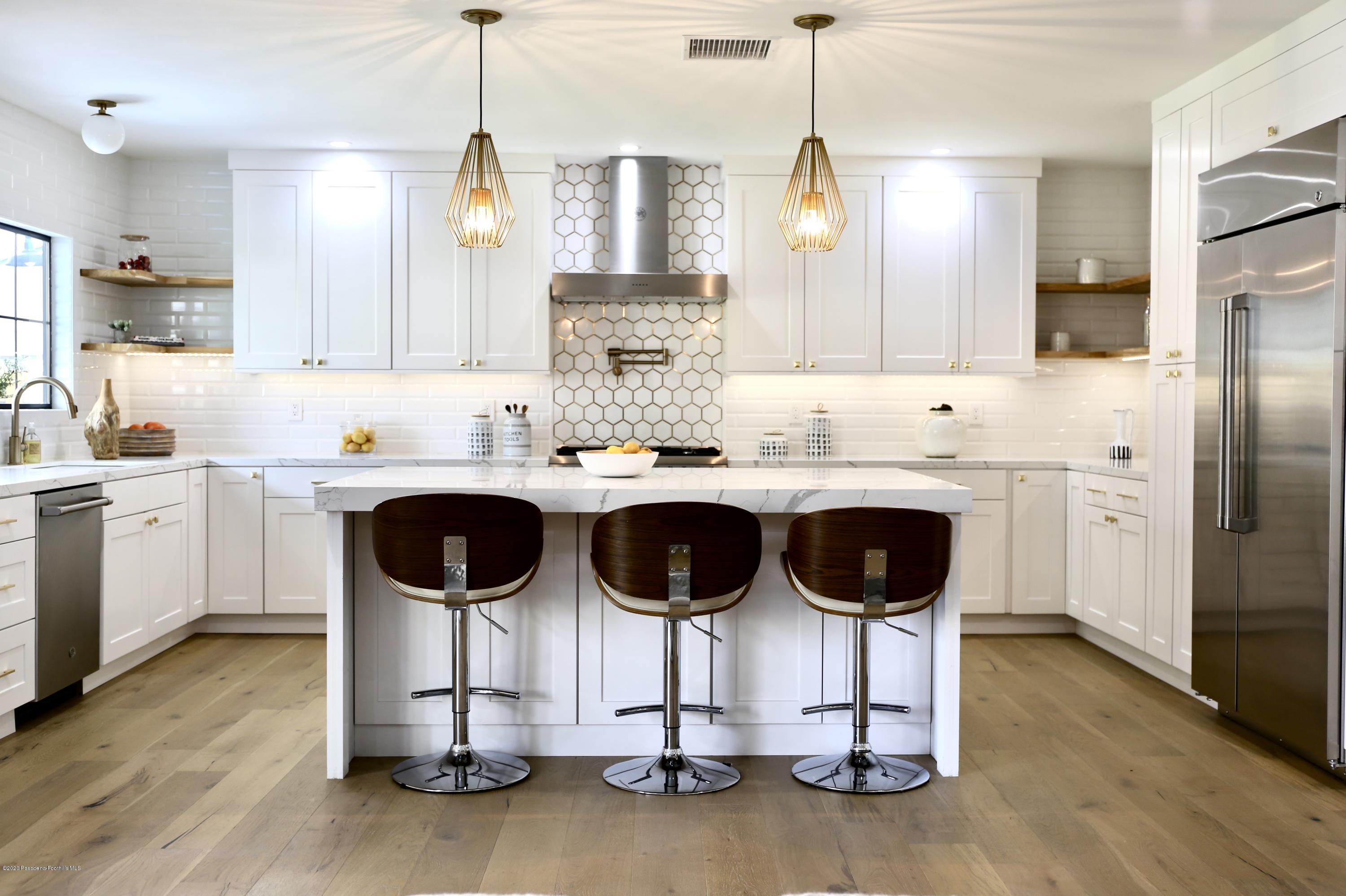 3665 Thorndale Road Pasadena, CA 91107 - Photo 16 of 45 a kitchen with kitchen island granite countertop a sink cabinets and stainless steel appliances