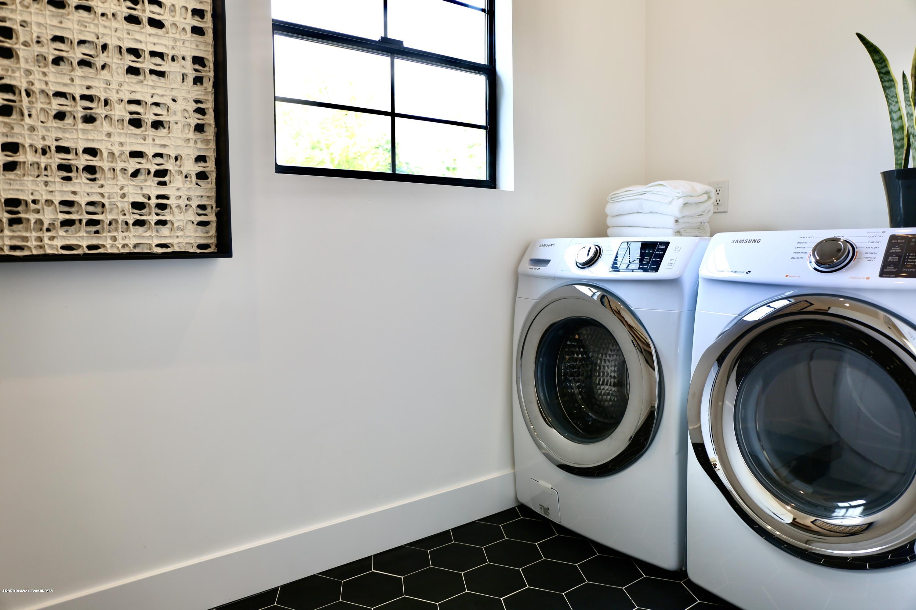 3665 Thorndale Road Pasadena, CA 91107 - Photo 35 of 45 a view of a storage and utility room with washer and dryer