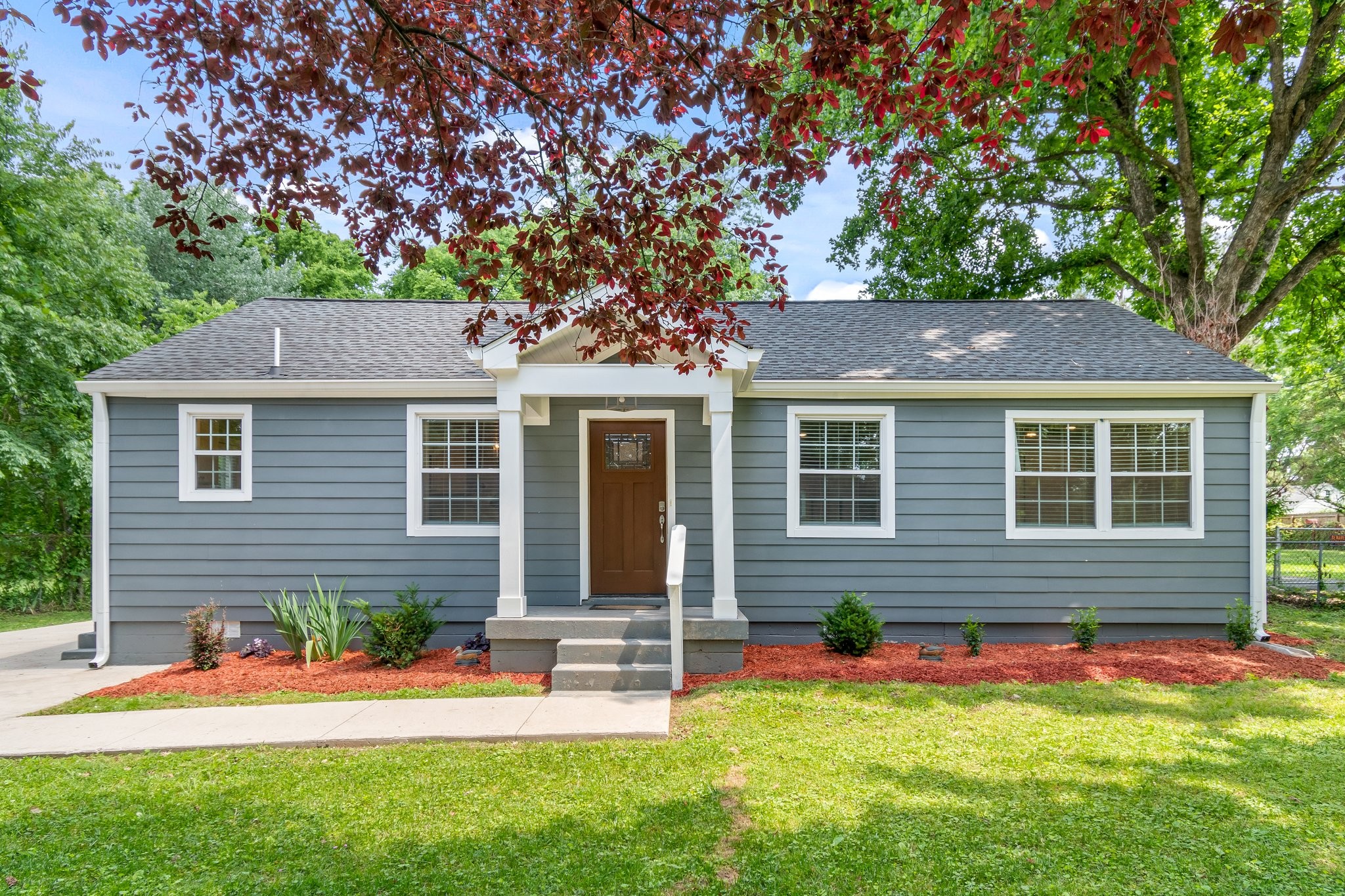 a front view of a house with a yard and porch