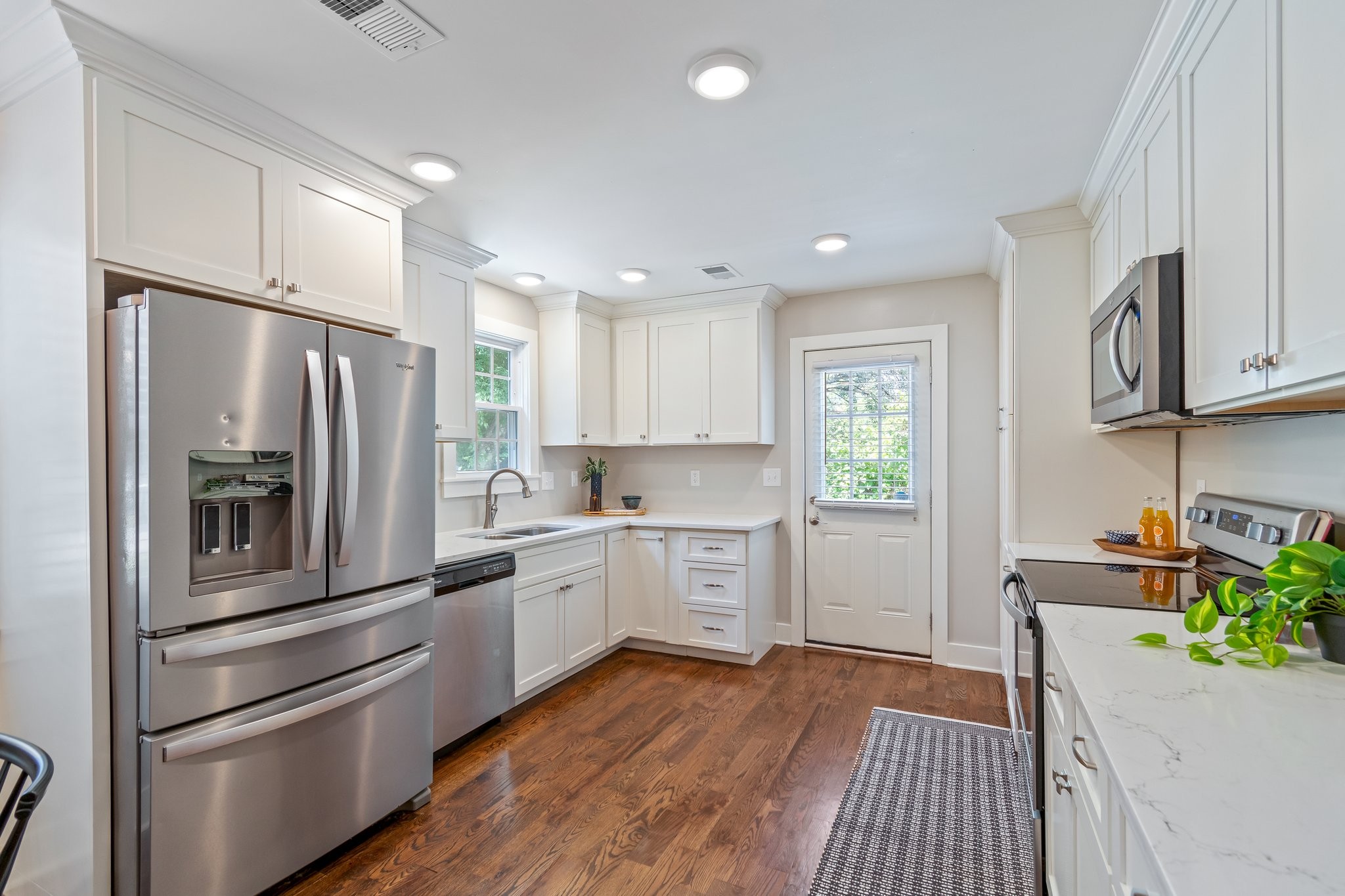 884 Kipling Drive Nashville, TN 37217 - Photo 12 of 40 a kitchen with a refrigerator stainless steel appliances wooden floor and cabinets