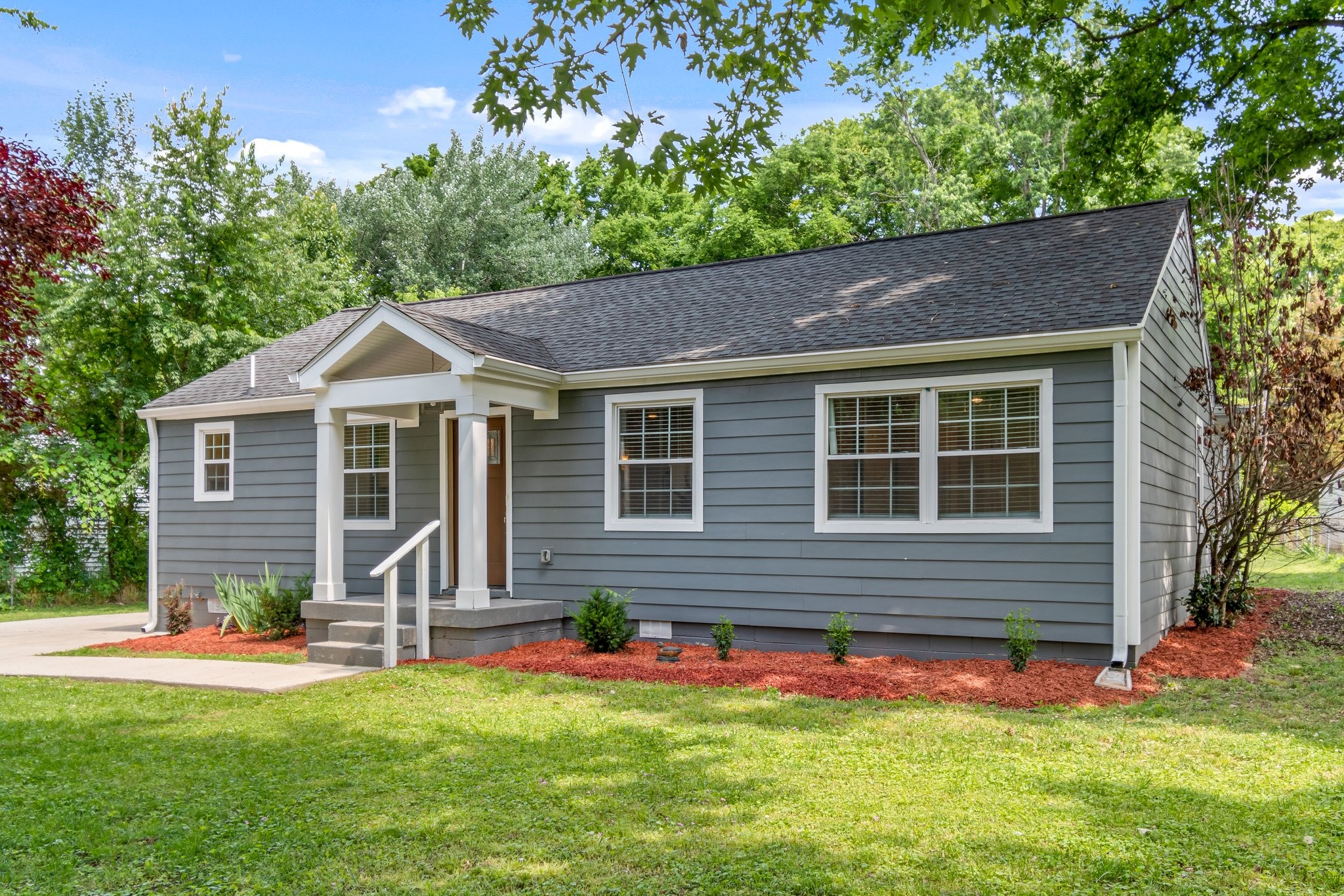884 Kipling Drive Nashville, TN 37217 - Photo 2 of 40 a front view of a house with a yard and garage