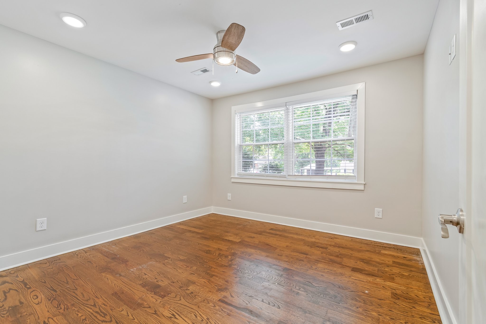 884 Kipling Drive Nashville, TN 37217 - Photo 32 of 40 an empty room with wooden floor and windows