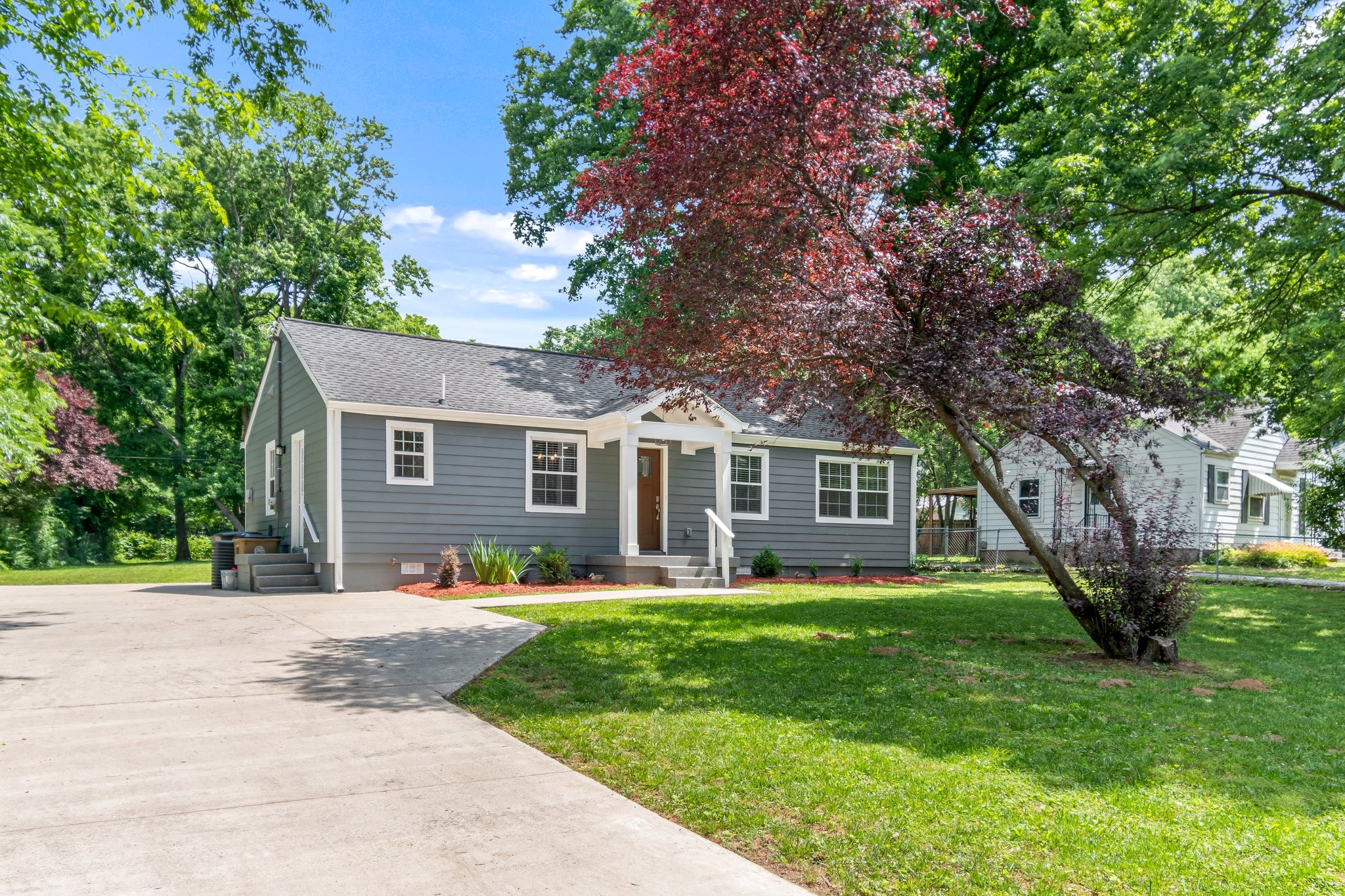 884 Kipling Drive Nashville, TN 37217 - Photo 4 of 40 a front view of house with a garden and trees