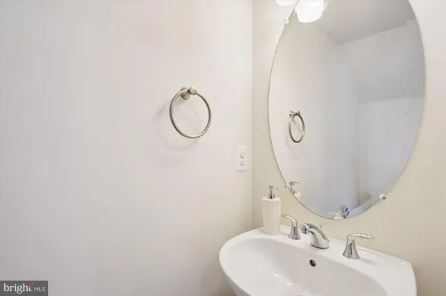 a bathroom with a sink and mirror