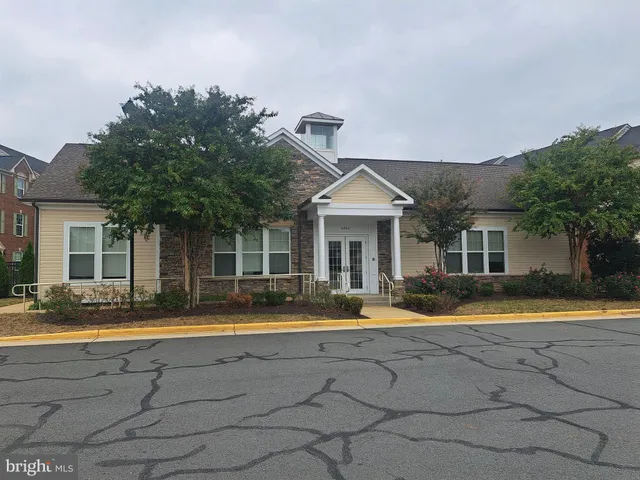 a front view of a house with a iron gate