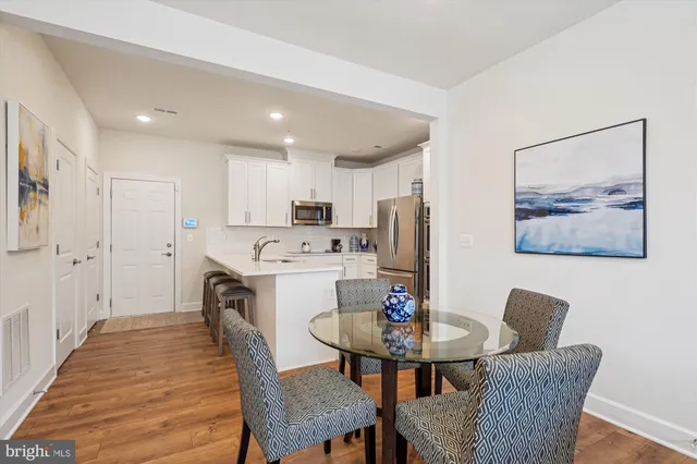a view of a dining room with furniture and wooden floor