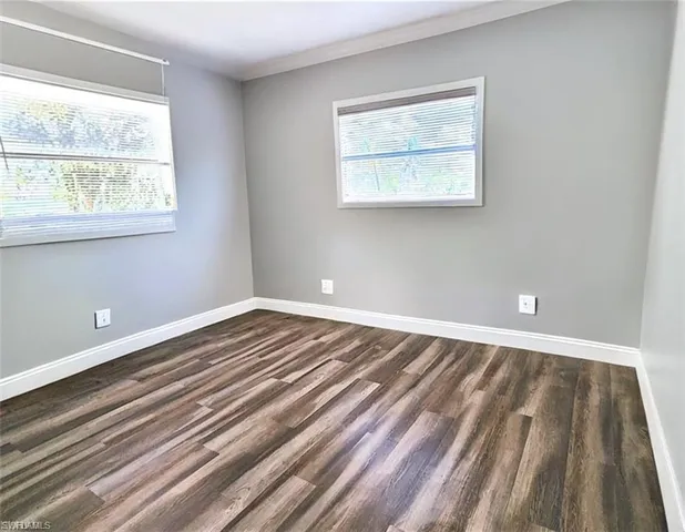 a view of a room with wooden floor and window