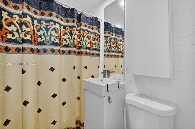a bathroom with a shower curtain and a sink