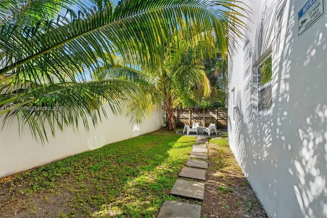 a view of a living room and a patio area of the house
