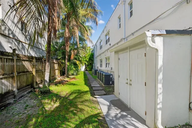 a view of a living room and a patio area of the house