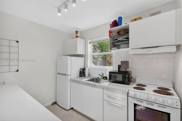 a kitchen with a refrigerator and a stove