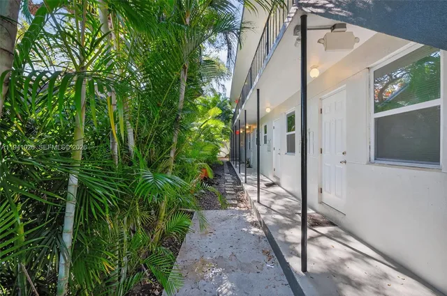 an aerial view of a house with garden space and street view