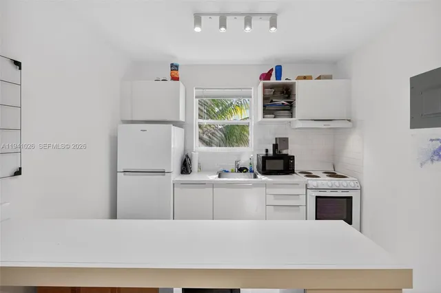 a kitchen with a cabinets and a refrigerator