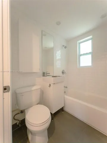 a bathroom with a toilet a sink and bathtub