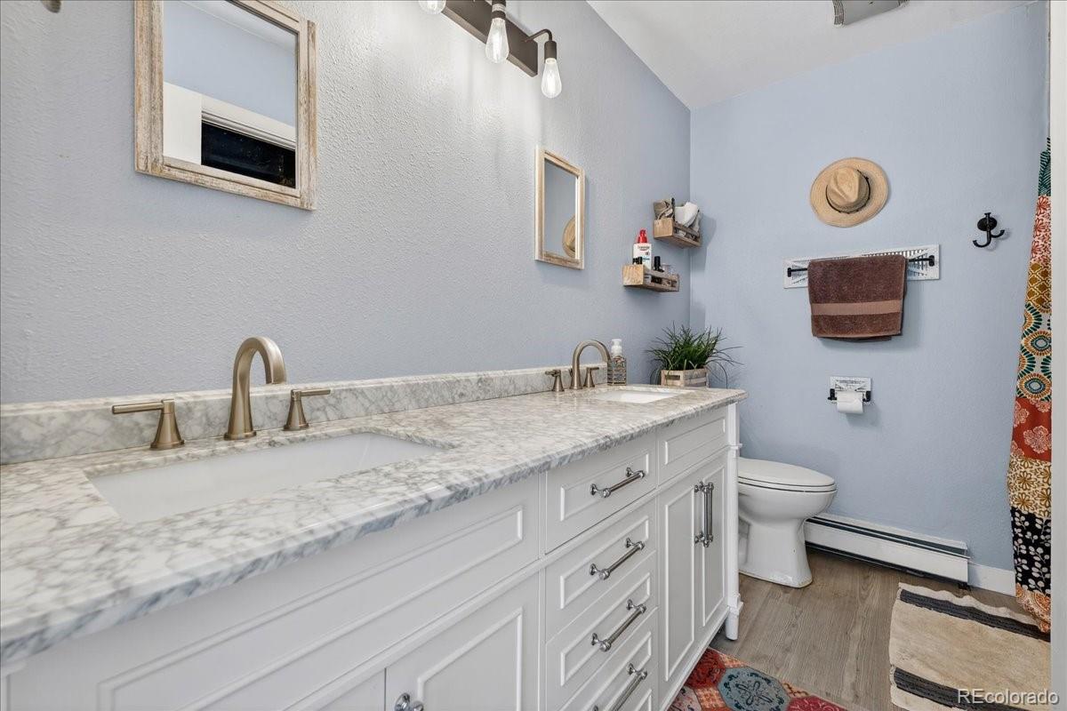 11827 Brook Road Golden, CO 80403 - Photo 14 of 32 a bathroom with a granite countertop toilet sink and mirror
