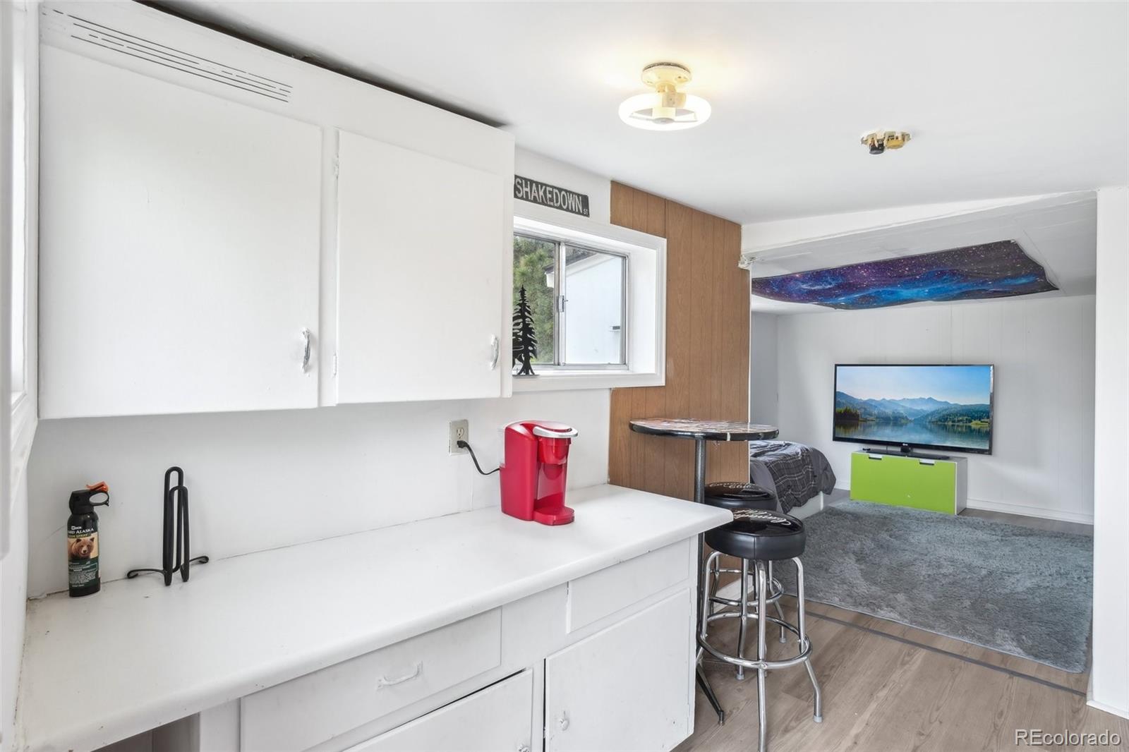 11827 Brook Road Golden, CO 80403 - Photo 21 of 32 a kitchen with a sink cabinets and wooden floor