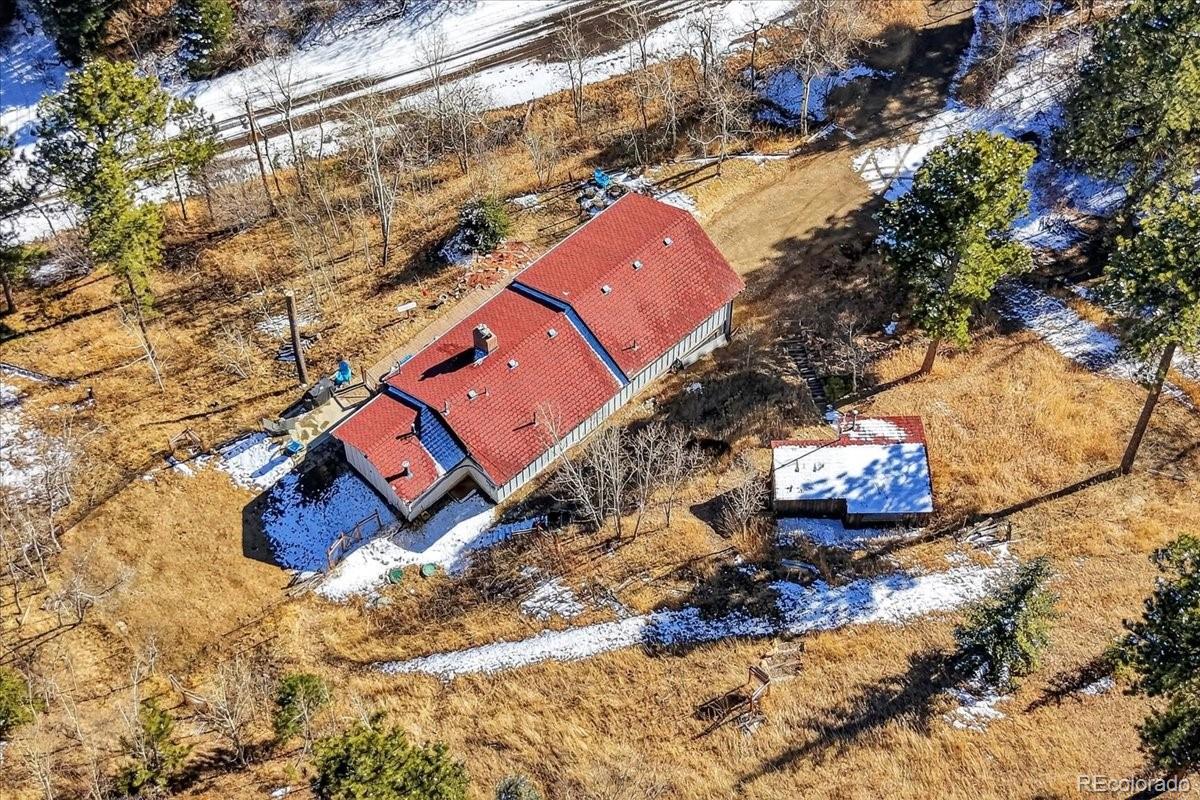 11827 Brook Road Golden, CO 80403 - Photo 25 of 32 a building outdoor space with swimming pool and trees in the background