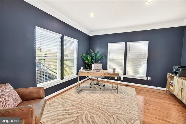a view of a dining room and livingroom with furniture wooden floor a chandelier