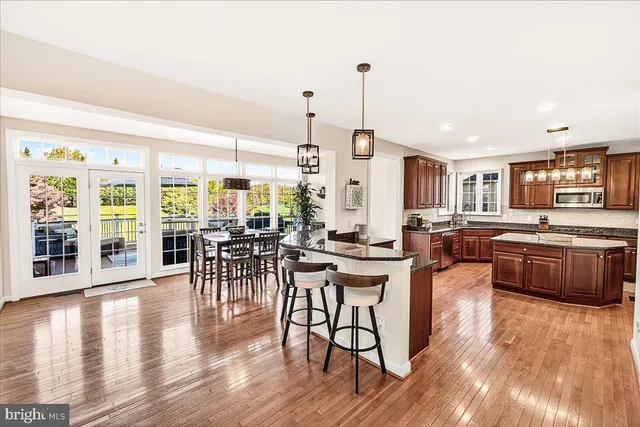 a kitchen with stainless steel appliances granite countertop a sink stove and cabinets
