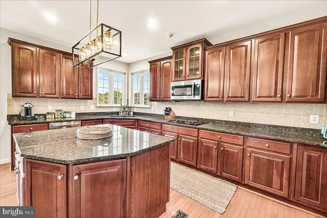 a spacious bedroom with a bed and a flat screen tv
