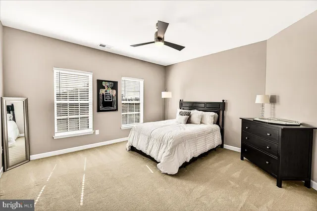 a view of a house with a big yard and large trees
