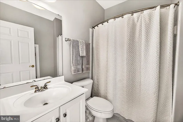 a view of a house with a big yard and large trees