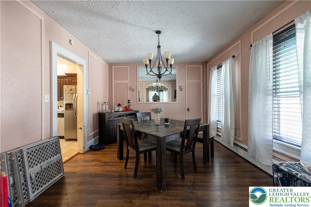 118 South 3rd Street Bangor, PA 18013 - Photo 10 of 33 This inviting dining area features elegant hardwood flooring and a stylish chandelier, ideal for memorable gatherings.