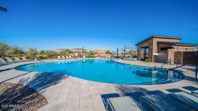 a view of a swimming pool with a yard