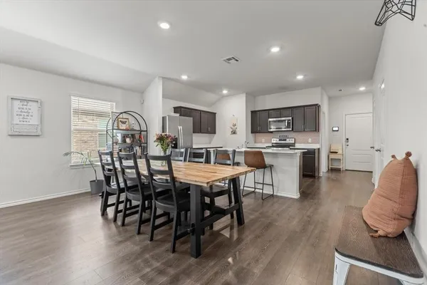 a view of a dining room with furniture and wooden floor