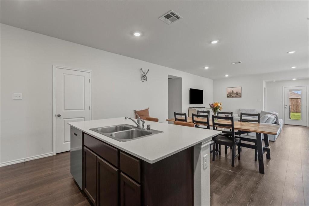 113 Keller Road Royse City, TX 75189 - Photo 20 of 25 a kitchen with stainless steel appliances granite countertop a sink a microwave and chairs