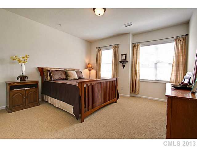 307 Wave Crest Drive, Unit 307 Tega Cay, SC 29708 - Photo 11 of 16 a bedroom with a bed and a flat screen tv