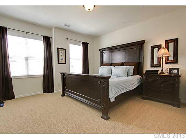 307 Wave Crest Drive, Unit 307 Tega Cay, SC 29708 - Photo 12 of 16 a bedroom with a bed and window