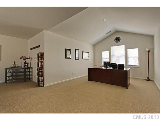 307 Wave Crest Drive, Unit 307 Tega Cay, SC 29708 - Photo 13 of 16 a living room with furniture and a flat screen tv