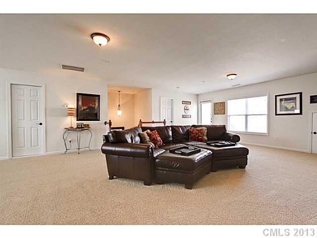 307 Wave Crest Drive, Unit 307 Tega Cay, SC 29708 - Photo 14 of 16 a living room with furniture and a large window