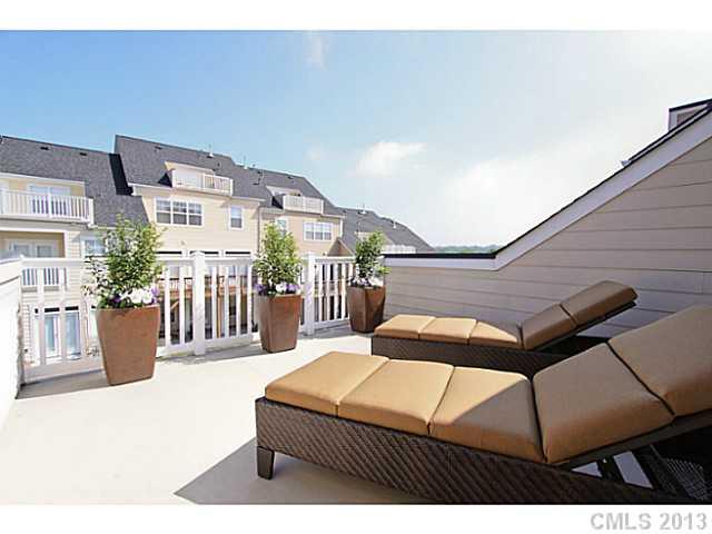 307 Wave Crest Drive, Unit 307 Tega Cay, SC 29708 - Photo 15 of 16 a bedroom with a bed a table and potted plants