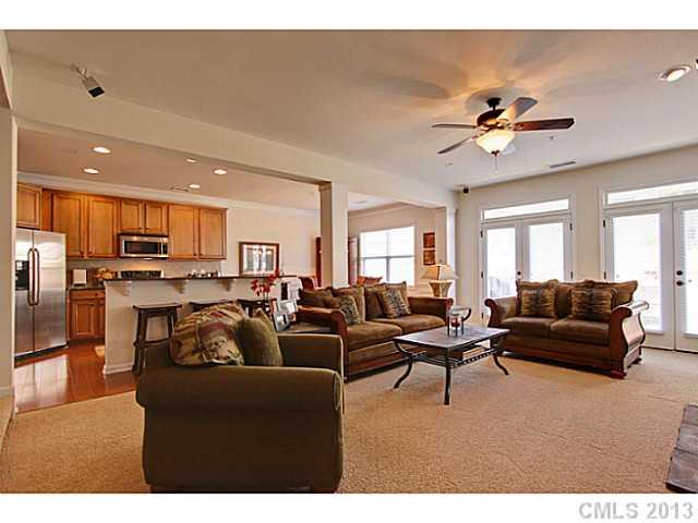 307 Wave Crest Drive, Unit 307 Tega Cay, SC 29708 - Photo 3 of 16 a living room with furniture kitchen view and a chandelier