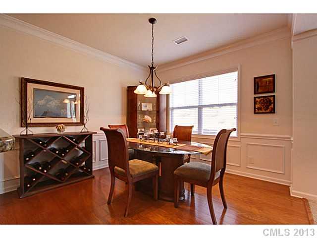 307 Wave Crest Drive, Unit 307 Tega Cay, SC 29708 - Photo 4 of 16 a dining room with furniture a chandelier and wooden floor